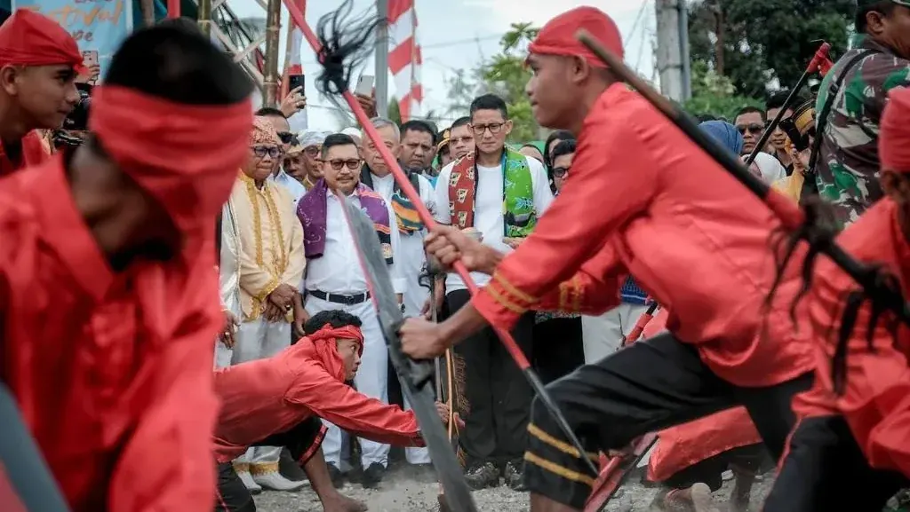 Dancers in red costume performing during a cultural festival